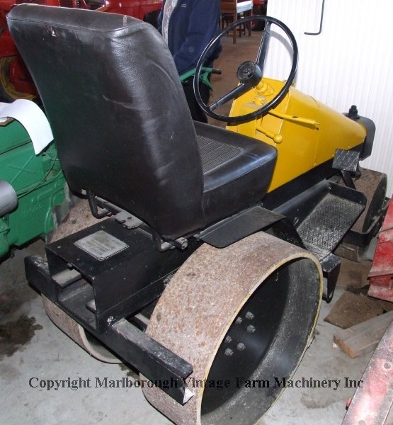Rear view of the small yellow Aveling Barford land roller.